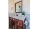 This powder room features a modern vanity with gray countertop and stainless steel fixtures at 10051 82Nd Ln, Seminole, FL 33777
