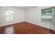 This cozy bedroom features hardwood floors and plenty of natural light from the two windows at 10051 82Nd Ln, Seminole, FL 33777