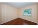 Well-lit bedroom with wood-look floors and a window providing natural light, offering a comfortable living space at 10051 82Nd Ln, Seminole, FL 33777