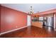 Open concept dining room featuring hardwood floors and easy access to the modern kitchen with stainless steel appliances at 10051 82Nd Ln, Seminole, FL 33777