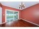 Dining room with hardwood floors and sliding glass doors, offering natural light and backyard access at 10051 82Nd Ln, Seminole, FL 33777