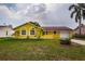 Charming yellow single-story home featuring a one-car garage and well-maintained front yard at 10051 82Nd Ln, Seminole, FL 33777