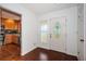 Inviting foyer featuring wood floors, a decorative front door, and view into kitchen at 10051 82Nd Ln, Seminole, FL 33777