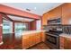 Modern kitchen with hardwood floors and stainless steel appliances, conveniently connects to an adjacent dining room at 10051 82Nd Ln, Seminole, FL 33777