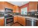 Modern kitchen features stainless steel appliances, custom backsplash, stylish cabinets, and lots of counter space at 10051 82Nd Ln, Seminole, FL 33777