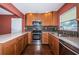 Modern kitchen featuring stainless steel appliances, custom backsplash, stylish cabinets, and lots of counter space at 10051 82Nd Ln, Seminole, FL 33777