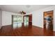 Spacious living room with hardwood floors, ceiling fan, and view into Florida room and kitchen at 10051 82Nd Ln, Seminole, FL 33777