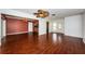 Spacious living room with hardwood floors, ceiling fan, and view into dining area and foyer at 10051 82Nd Ln, Seminole, FL 33777