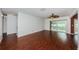 Spacious living room with hardwood floors, ceiling fan, and sliding glass door to Florida room at 10051 82Nd Ln, Seminole, FL 33777