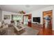 Bright living room showcasing hardwood floors, comfortable seating, and access to the dining area and kitchen at 10051 82Nd Ln, Seminole, FL 33777