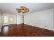 Spacious living room featuring wood floors, a decorative front door, and white walls at 10051 82Nd Ln, Seminole, FL 33777