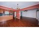 Spacious living room with hardwood floors and easy access to the modern kitchen with stainless steel appliances at 10051 82Nd Ln, Seminole, FL 33777