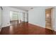 This spacious main bedroom features rich wood flooring, a large closet, and an ensuite bathroom at 10051 82Nd Ln, Seminole, FL 33777