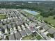 A neighborhood boasts a scenic water view and lush green spaces in an aerial shot at 10202 White Linen Ave, Riverview, FL 33578