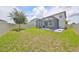 Spacious backyard featuring a screened patio with outdoor seating, and landscaping at 10202 White Linen Ave, Riverview, FL 33578