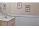 Contemporary bathroom with modern vanity, stylish mirror, and decorative artwork at 10202 White Linen Ave, Riverview, FL 33578
