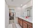 Double sink bathroom has cabinets, a large mirror, and shower with a walk-in closet at 10202 White Linen Ave, Riverview, FL 33578