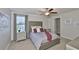 Comfortable bedroom with plush carpet, upholstered headboard, and soft, neutral color scheme at 10202 White Linen Ave, Riverview, FL 33578