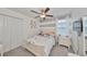 Cozy bedroom featuring a ceiling fan, closet, and a bright window with blinds at 10202 White Linen Ave, Riverview, FL 33578