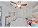 Bright bedroom features a closet, ceiling fan, dresser, and large window providing ample natural light at 10202 White Linen Ave, Riverview, FL 33578