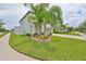 Two-story home with a landscaped lawn, complemented by mature trees and a welcoming entrance at 10202 White Linen Ave, Riverview, FL 33578
