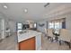 Well-lit kitchen island with sink overlooks dining area and living space with plush seating at 10202 White Linen Ave, Riverview, FL 33578