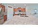 Elegant kitchen island with marble countertop and stainless steel appliances against beautiful mosaic backsplash at 10202 White Linen Ave, Riverview, FL 33578