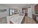 Modern kitchen with an island, stainless steel appliances, and adjacent dining area at 10202 White Linen Ave, Riverview, FL 33578