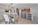 Charming eat-in kitchen with wood cabinets, stainless steel appliances, tile backsplash, and breakfast bar at 10202 White Linen Ave, Riverview, FL 33578