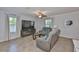 Inviting living room with tile flooring, sofas, and large-screen television display at 10202 White Linen Ave, Riverview, FL 33578