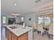 Open concept living space featuring kitchen island, dining table, and living room area at 10202 White Linen Ave, Riverview, FL 33578