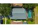 Aerial view of home showing the roof, backyard, screened in pool, and surrounding landscaping at 10819 Newbridge Dr, Riverview, FL 33579