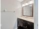 Modern bathroom with dark wood vanity, and large mirror at 10819 Newbridge Dr, Riverview, FL 33579