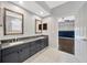 Stylish bathroom with a double sink vanity, a view to the bedroom, and tiled floors at 10819 Newbridge Dr, Riverview, FL 33579