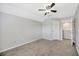 Empty bedroom with neutral walls, plush carpet and en suite bathroom access at 10819 Newbridge Dr, Riverview, FL 33579