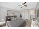 Cozy bedroom with a plush bed, modern art and bright, neutral walls at 10819 Newbridge Dr, Riverview, FL 33579