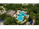 Aerial view of the community pool area with lush landscaping and plenty of space to relax at 10819 Newbridge Dr, Riverview, FL 33579