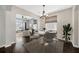 Elegant dining area with modern chandelier, table setting, and view of living room at 10819 Newbridge Dr, Riverview, FL 33579