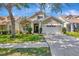 Charming home with a two-car garage, well-manicured lawn, and lovely landscaping at 10819 Newbridge Dr, Riverview, FL 33579