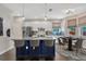 Modern kitchen with a large island, stainless steel appliances, and adjacent dining area at 10819 Newbridge Dr, Riverview, FL 33579