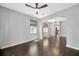 Open-concept layout with hardwood floors connecting the living room and dining space at 10819 Newbridge Dr, Riverview, FL 33579