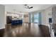 Open floor plan with hardwood floors, a modern kitchen with an island, and access to the pool at 10819 Newbridge Dr, Riverview, FL 33579