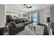 Bright living room with modern decor, hardwood floors, and sliding glass doors to the pool at 10819 Newbridge Dr, Riverview, FL 33579