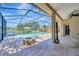 Screened in pool and hot tub area with a fire pit and lake view at 10819 Newbridge Dr, Riverview, FL 33579