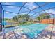 Screened pool and hot tub area with fountain feature and lake view at 10819 Newbridge Dr, Riverview, FL 33579
