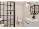 Modern bathroom featuring black framed shower, elegant fixtures, and clean design at 1145 53Rd N Ave, St Petersburg, FL 33703