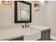 Bathroom vanity features a black faucet and framed mirror with modern lighting fixtures at 1145 53Rd N Ave, St Petersburg, FL 33703