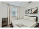 This bedroom includes natural light, simple decorations, and a swan-shaped towel on the bed at 1145 53Rd N Ave, St Petersburg, FL 33703