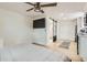 Studio apartment featuring light wood floors, a ceiling fan, a bed, and a modern bathroom at 1145 53Rd N Ave, St Petersburg, FL 33703