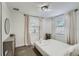 Bright bedroom featuring two windows, neutral decor, and a twin-sized bed with white linens at 1145 53Rd N Ave, St Petersburg, FL 33703